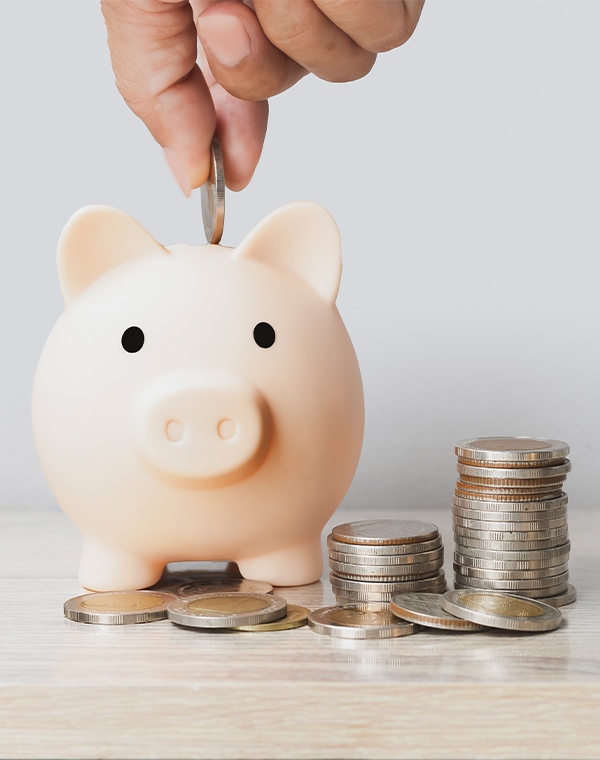 hand putting coins in piggy bank income strategy for retirement