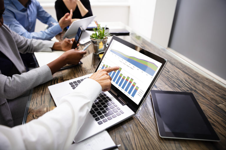 financial professionals looking at graphs on laptop life insurance in retirement